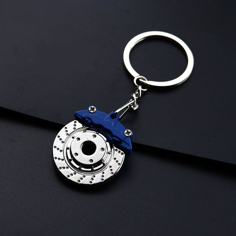 Porta-Chaves em formato de disco travão com cabeça azul e disco cinzento metálico, porta-chaves interativo que roda